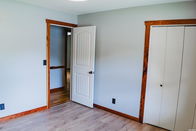 114 Roy Cir, Monticello, AR 71655 - unfurnished bedroom featuring baseboards, light wood-style floors, and a closet