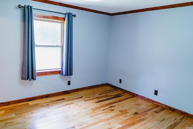 114 Roy Cir, Monticello, AR 71655 - empty room featuring healthy amount of natural light, wood finished floors, baseboards, and crown molding