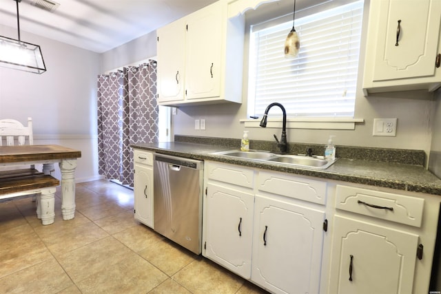 kitchen featuring dark countertops, decorative light fixtures, dishwasher, and a sink