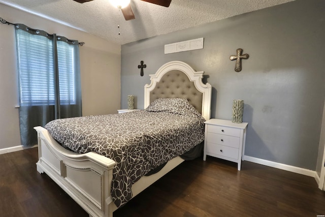 bedroom featuring a ceiling fan, dark wood finished floors, a textured ceiling, and baseboards