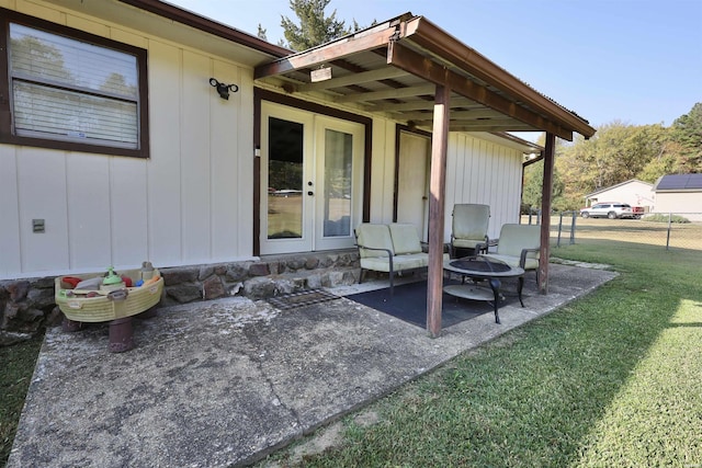 view of patio featuring french doors, an outdoor fire pit, and fence