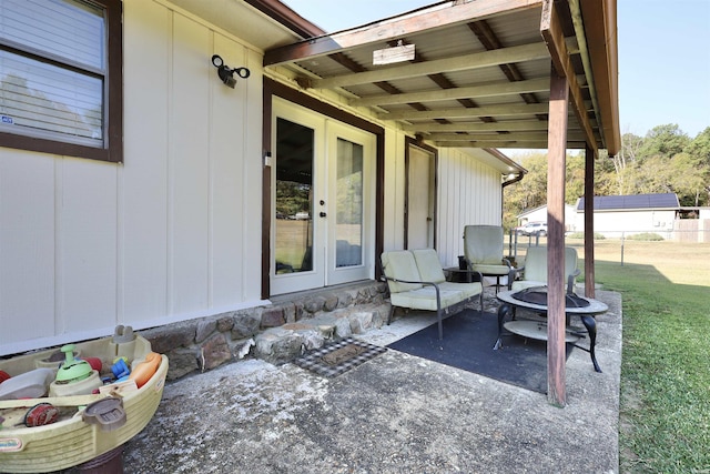 view of patio featuring a fire pit, french doors, and fence