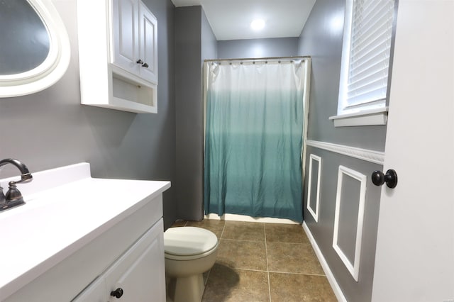 bathroom with tile patterned flooring, vanity, toilet, and a shower with curtain