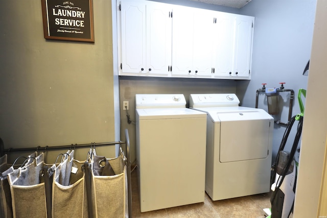 laundry room featuring cabinet space and washing machine and clothes dryer