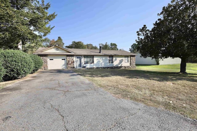 ranch-style home featuring aphalt driveway, stone siding, a front lawn, and a garage