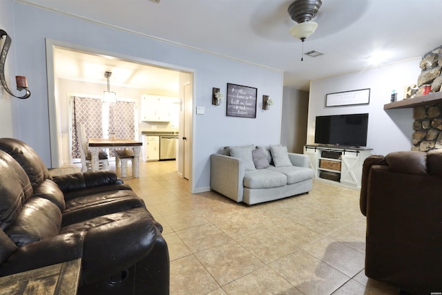 living room featuring light tile patterned floors, visible vents, and a ceiling fan