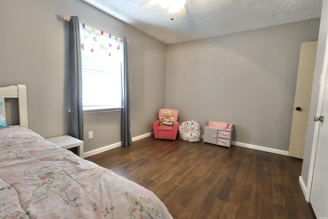 bedroom featuring dark wood-style floors, ceiling fan, a textured ceiling, and baseboards