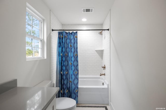 full bath with visible vents, baseboards, toilet, shower / bathtub combination with curtain, and vanity