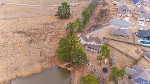 drone / aerial view featuring a water view and a residential view