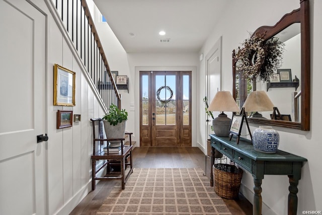 entryway with dark wood-type flooring, recessed lighting, visible vents, and stairs