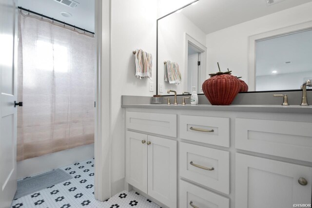 full bath with tile patterned flooring and vanity