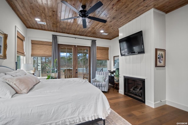 bedroom with baseboards, wooden ceiling, dark wood-style flooring, access to exterior, and a fireplace