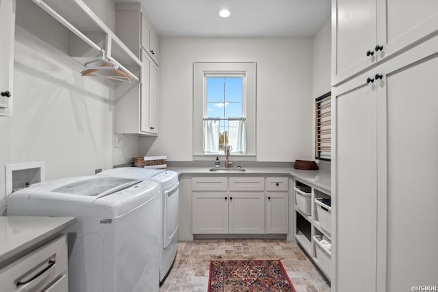 laundry room featuring cabinet space, washer and dryer, a sink, and recessed lighting