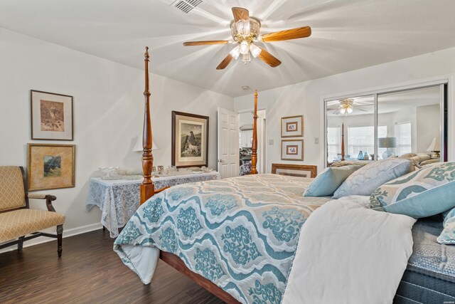 bedroom with dark wood finished floors, a closet, visible vents, a ceiling fan, and baseboards