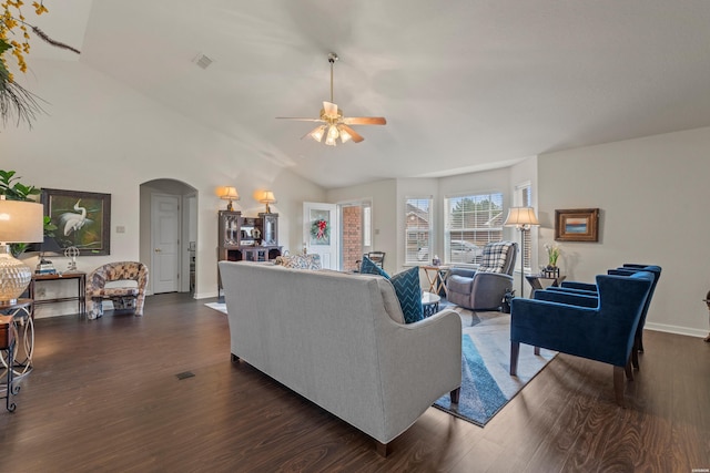 living area featuring visible vents, arched walkways, a ceiling fan, lofted ceiling, and dark wood-style floors