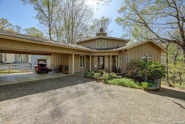 view of front of house featuring a carport, driveway, and board and batten siding