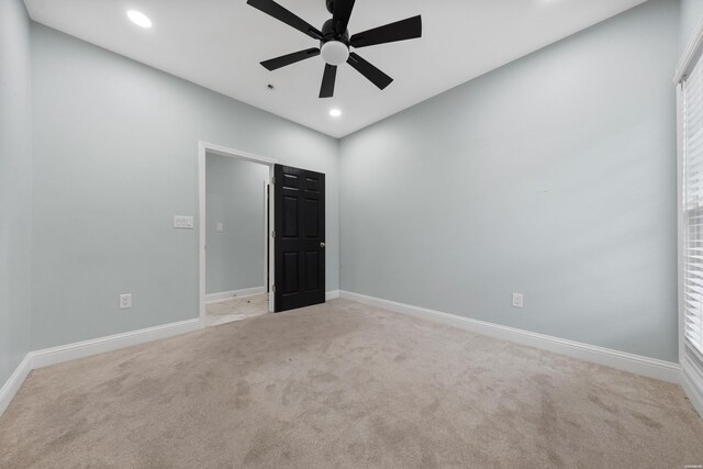 unfurnished room featuring recessed lighting, light colored carpet, ceiling fan, and baseboards