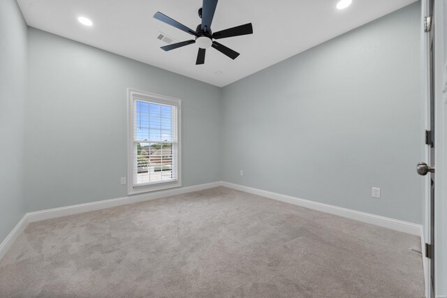 empty room featuring light carpet, recessed lighting, visible vents, and baseboards