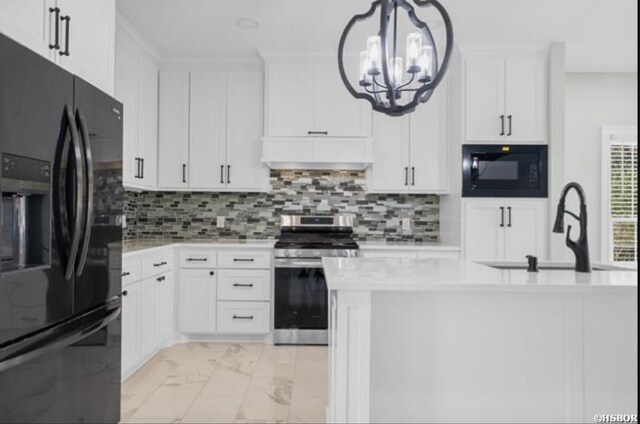 kitchen with pendant lighting, custom exhaust hood, light countertops, white cabinetry, and black appliances