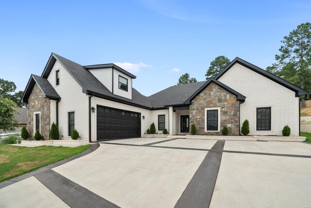 modern inspired farmhouse featuring brick siding and driveway