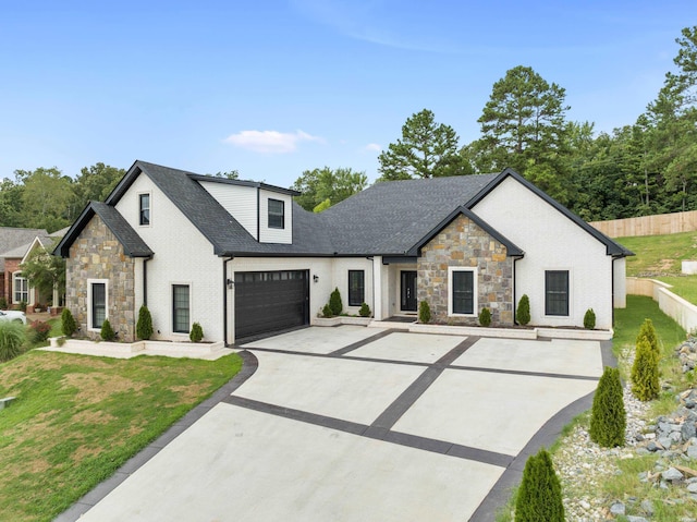 modern inspired farmhouse with a shingled roof, fence, a front lawn, and concrete driveway