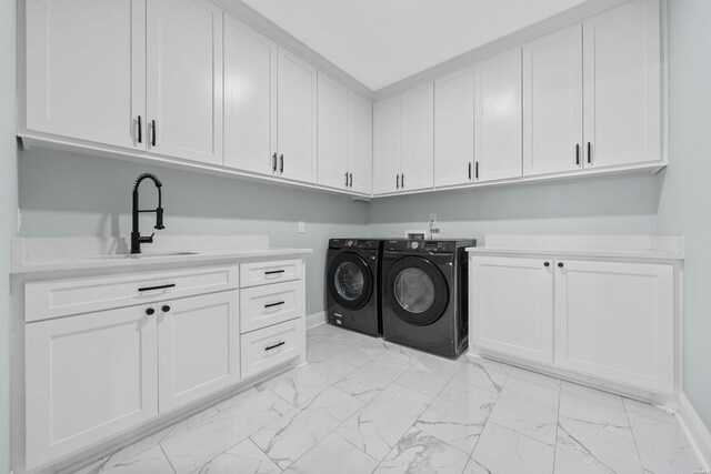 laundry room with marble finish floor, cabinet space, a sink, and separate washer and dryer