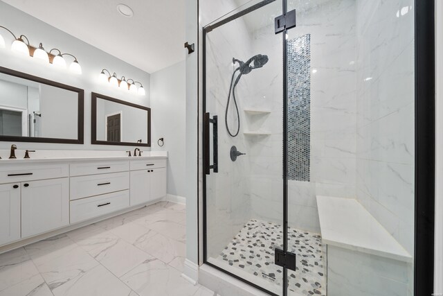 bathroom with marble finish floor, double vanity, a sink, and a marble finish shower