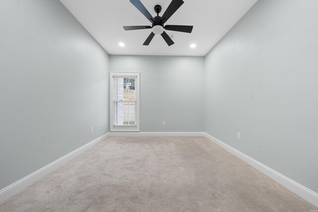 spare room featuring ceiling fan, recessed lighting, light colored carpet, and baseboards