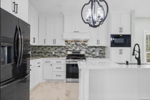 kitchen with black appliances, light countertops, a sink, and decorative light fixtures