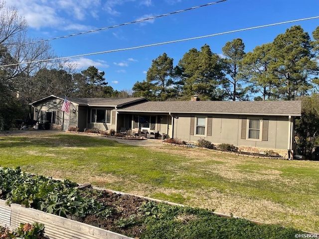 view of front facade with a front lawn and stucco siding