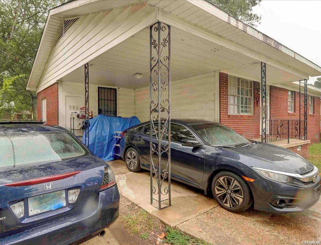 view of side of home with a carport