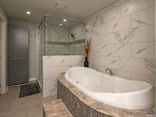 9925 Echo Valley Ct, Little Rock, AR 72227 - full bathroom with a garden tub, a stall shower, recessed lighting, and tile walls