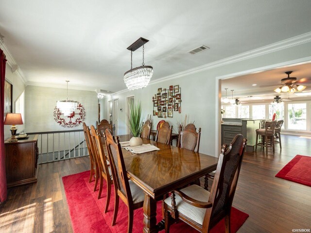 9925 Echo Valley Ct, Little Rock, AR 72227 - dining space featuring a chandelier, wood finished floors, ornamental molding, and a ceiling fan