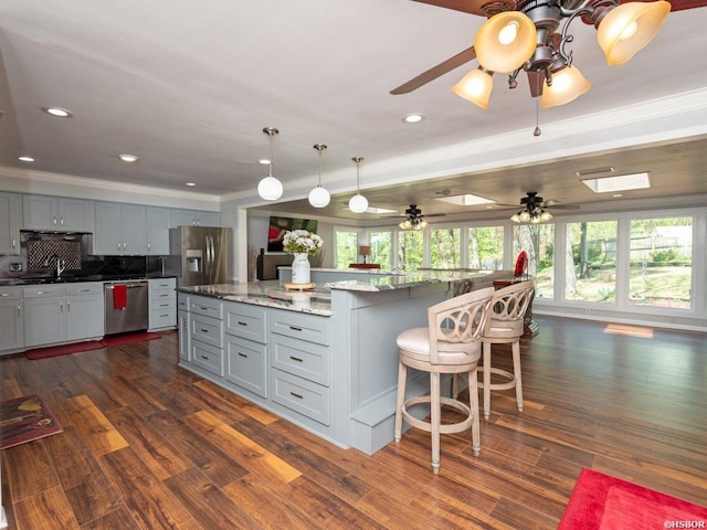 9925 Echo Valley Ct, Little Rock, AR 72227 - kitchen featuring stainless steel appliances, plenty of natural light, gray cabinetry, ornamental molding, and a large island