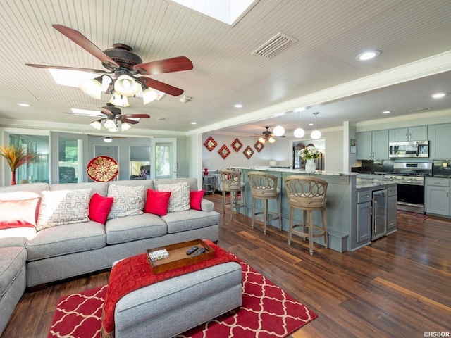 9925 Echo Valley Ct, Little Rock, AR 72227 - living area with ceiling fan, dark wood-style floors, recessed lighting, ornamental molding, and a skylight