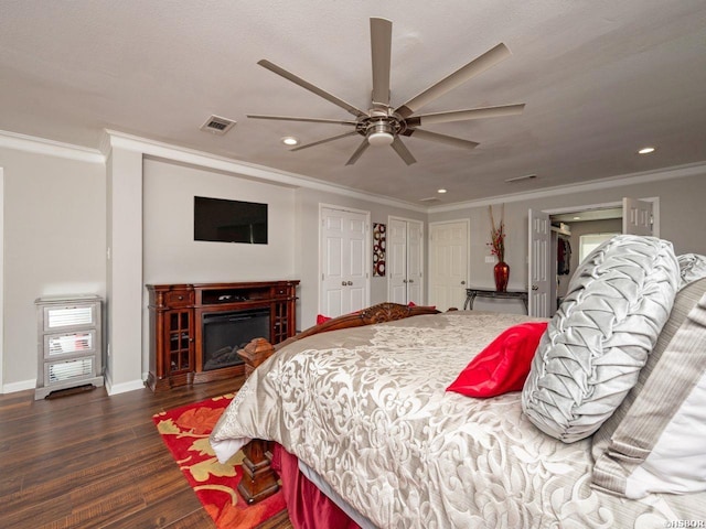 9925 Echo Valley Ct, Little Rock, AR 72227 - bedroom with ornamental molding, wood finished floors, recessed lighting, multiple closets, and a glass covered fireplace