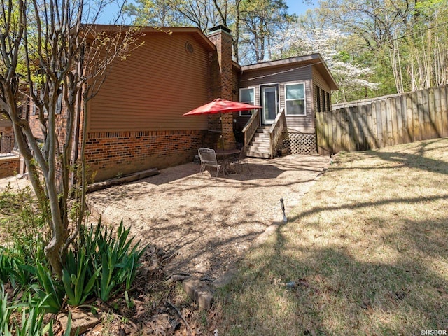 9925 Echo Valley Ct, Little Rock, AR 72227 - rear view of house with a chimney, brick siding, and a patio