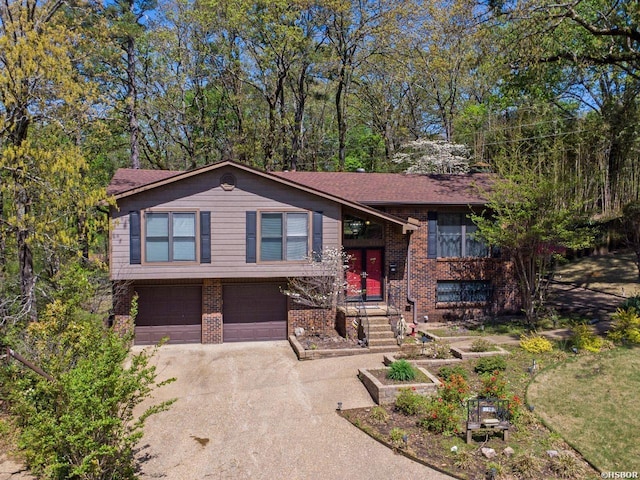 9925 Echo Valley Ct, Little Rock, AR 72227 - bi-level home featuring driveway, a garage, and brick siding