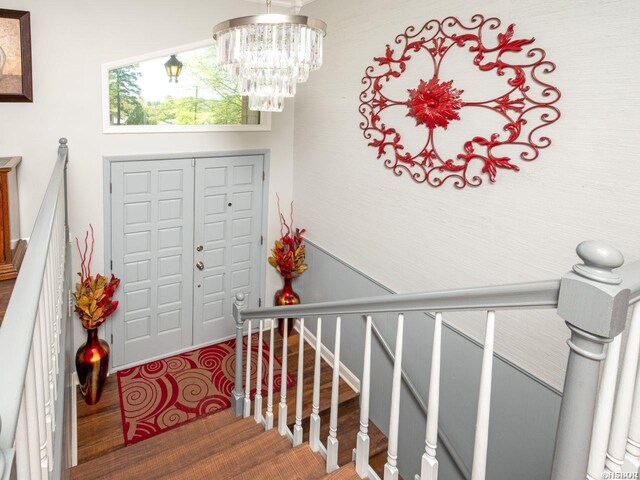 9925 Echo Valley Ct, Little Rock, AR 72227 - foyer entrance with wood finished floors and a chandelier