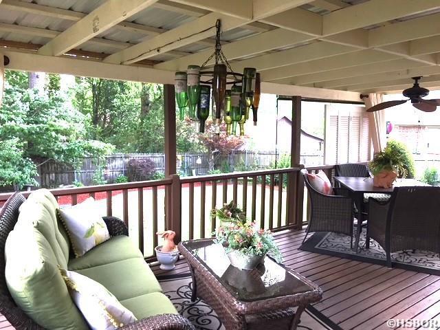 wooden deck featuring outdoor dining space, outdoor lounge area, and fence