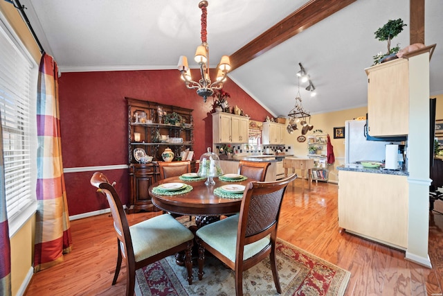 dining room featuring vaulted ceiling with beams, light wood finished floors, plenty of natural light, and an inviting chandelier