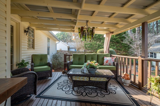 wooden terrace with an outdoor living space