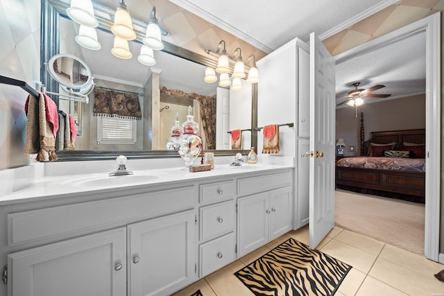 full bathroom with ornamental molding, a sink, a textured ceiling, and double vanity