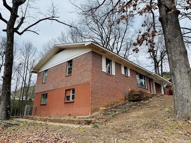 view of side of home with brick siding