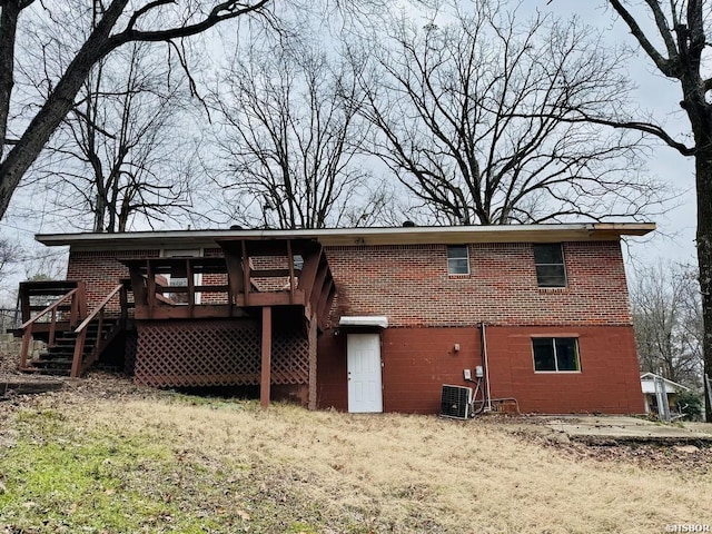 back of house featuring brick siding, stairway, a wooden deck, and central air condition unit