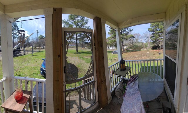 wooden deck featuring a lawn