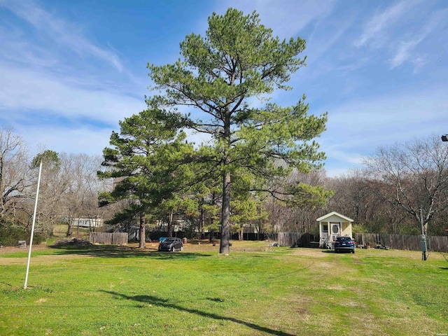 view of property's community featuring fence and a yard