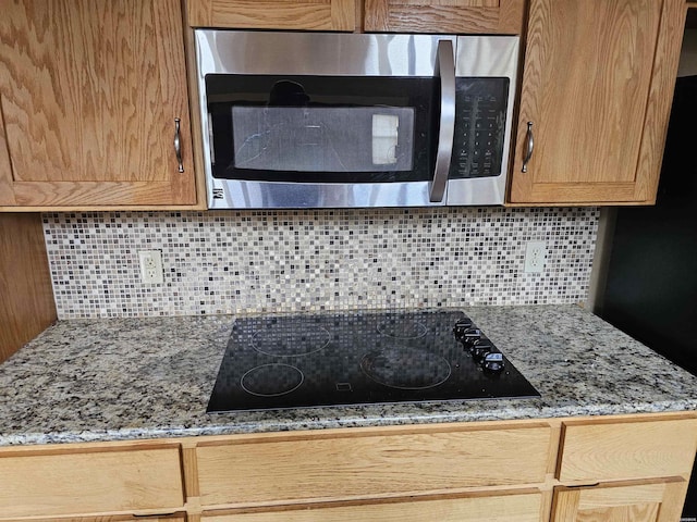 161 Funderburg Rd, Mineral Springs, AR 71851 - details with decorative backsplash, black electric cooktop, and stainless steel microwave