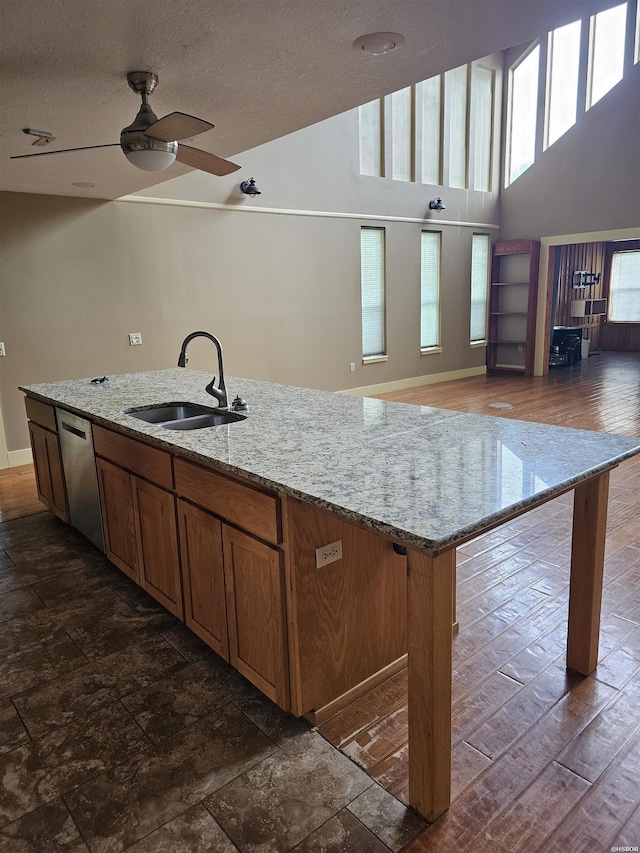 161 Funderburg Rd, Mineral Springs, AR 71851 - kitchen with a kitchen island with sink, a ceiling fan, stainless steel dishwasher, brown cabinets, and a sink