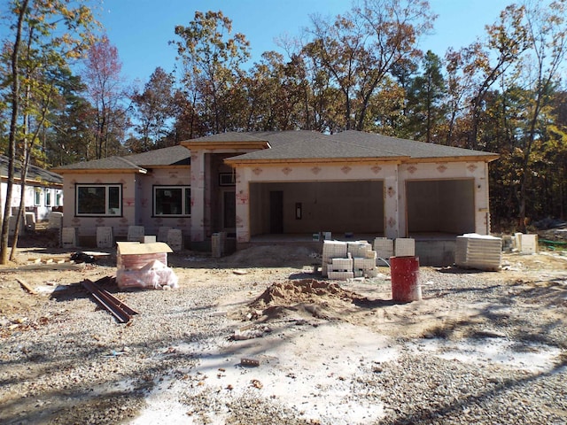 view of front of house with an attached garage and central air condition unit